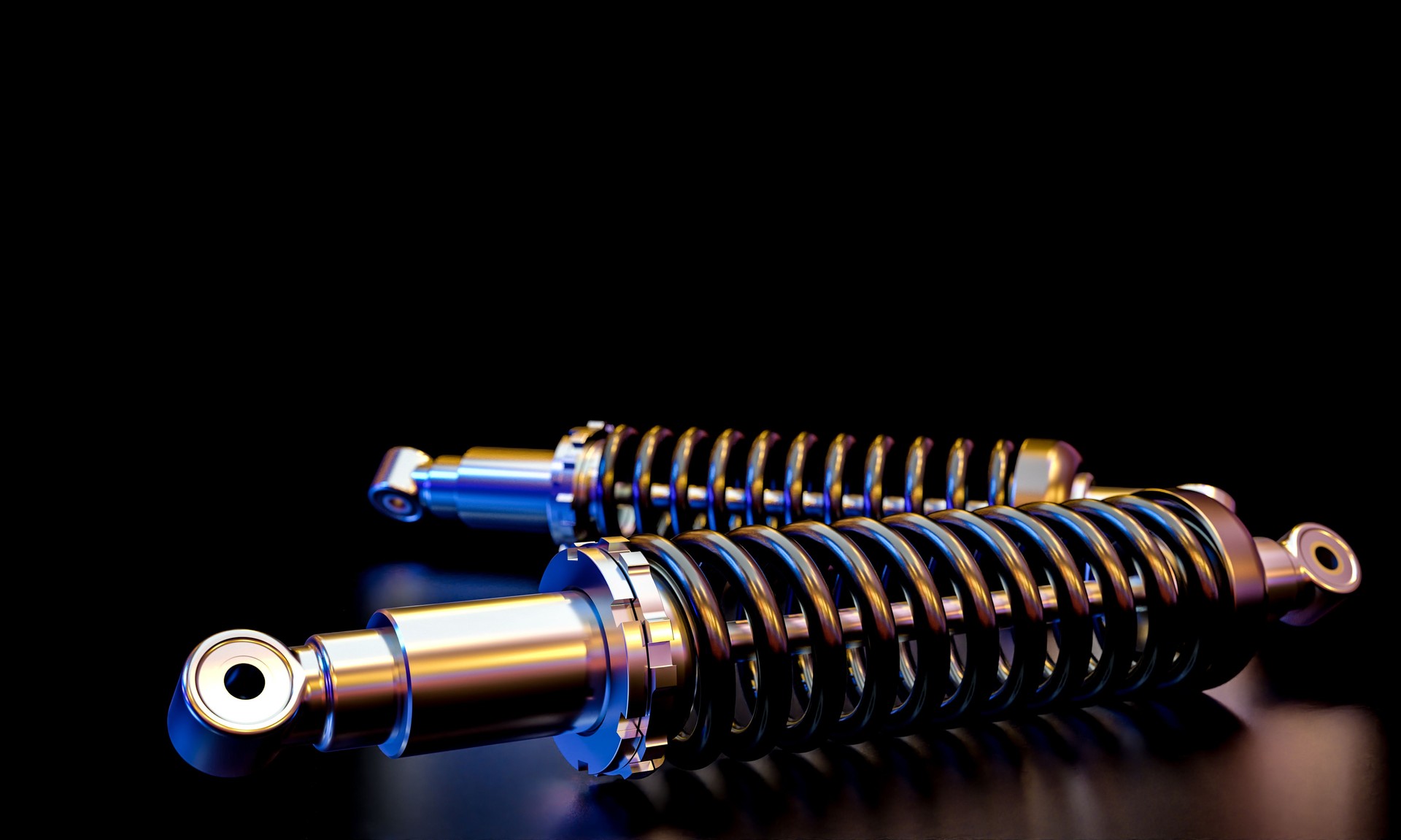 car shock absorbers on dark background.